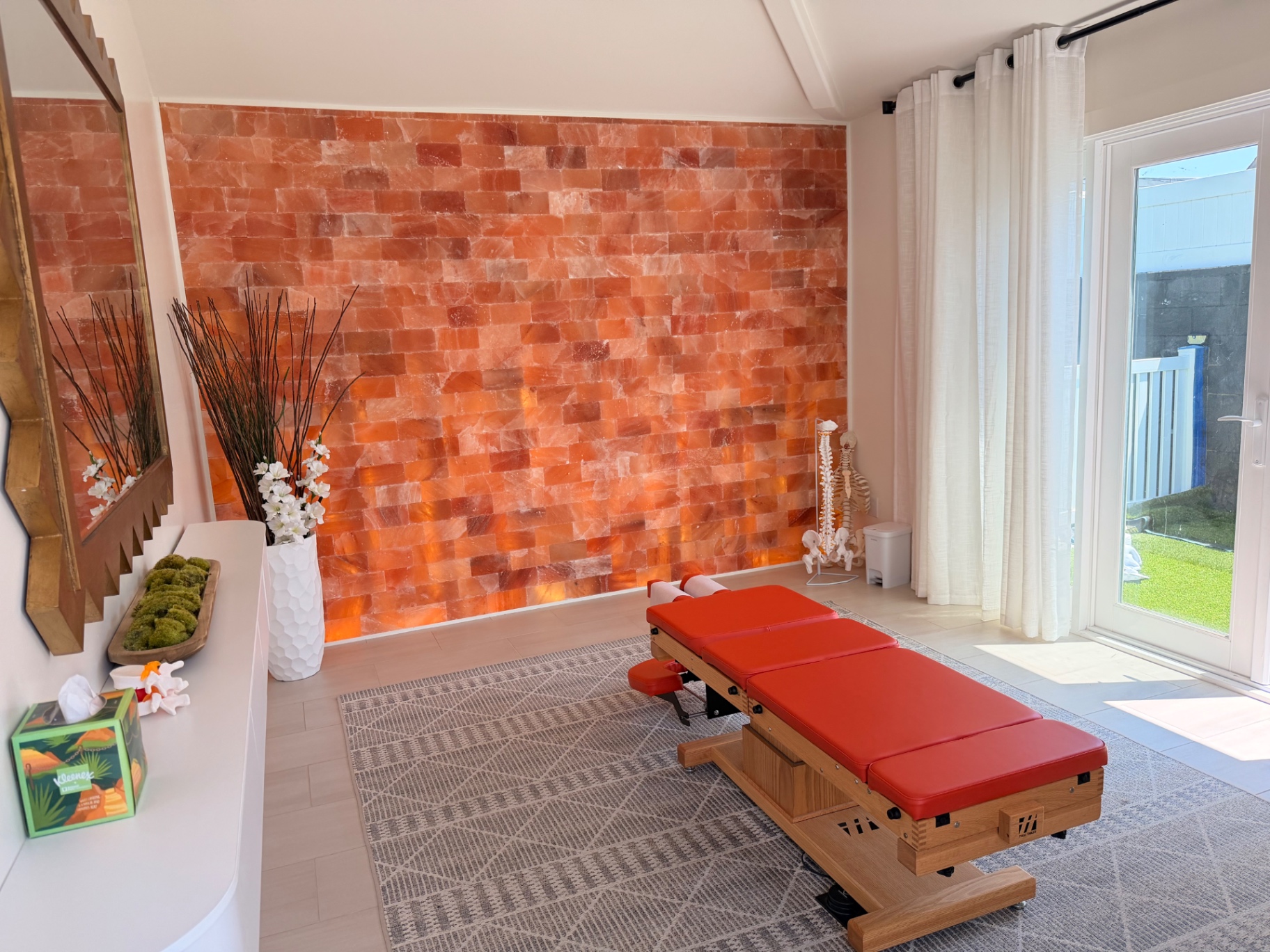 Treatment room at Hooked On Health Chiropractic with a glowing Himalayan salt rock wall